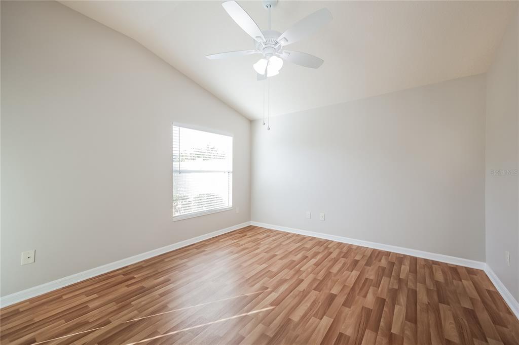 2294 Trailwinds Terrace The Villages, FL 32162 - Photo 8 of 16 wooden floor in an empty room with a window