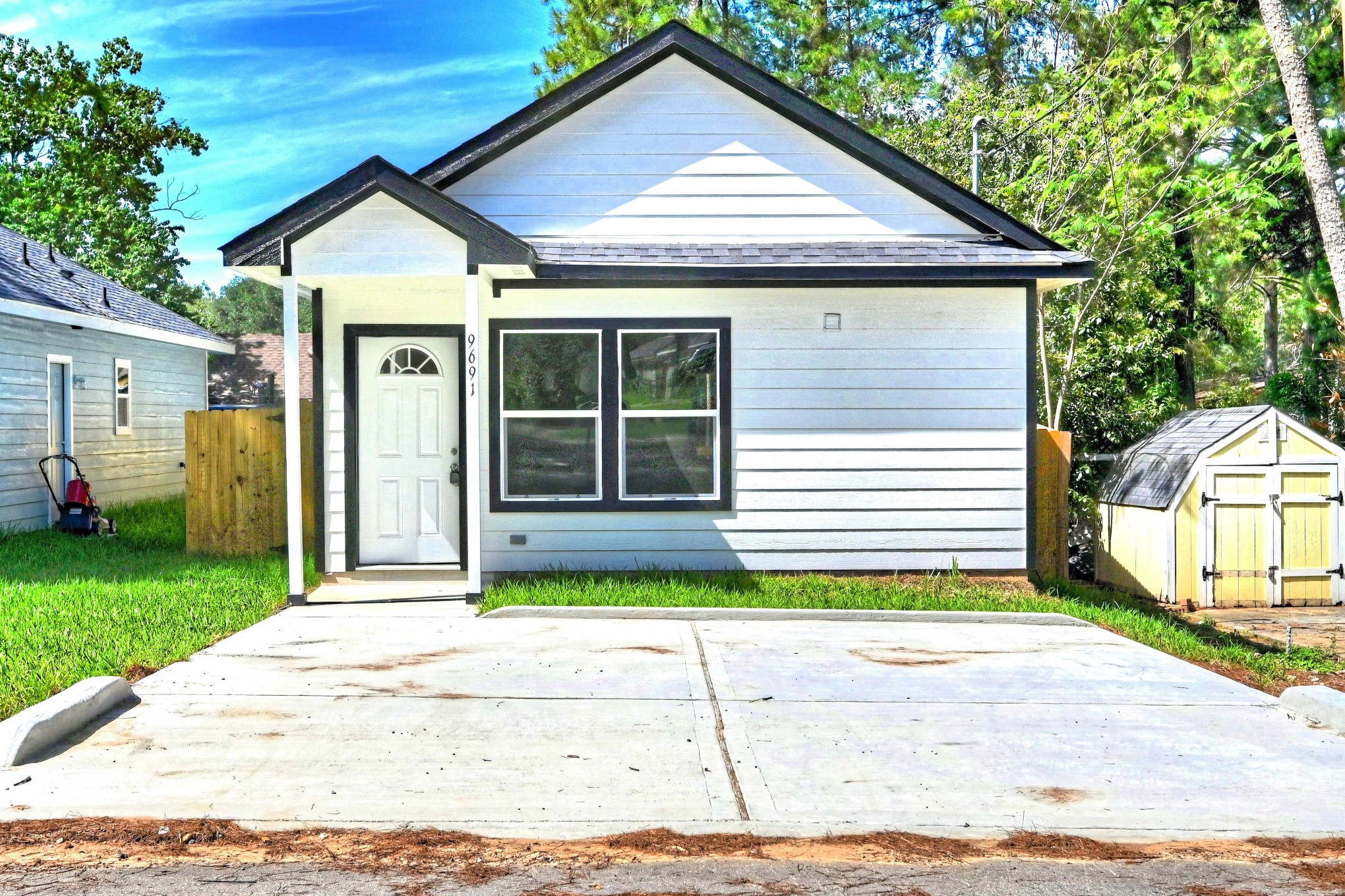 9812 Arbor Oak Willis, TX 77318 - Photo 1 of 40 a front view of a house with a garden and plants