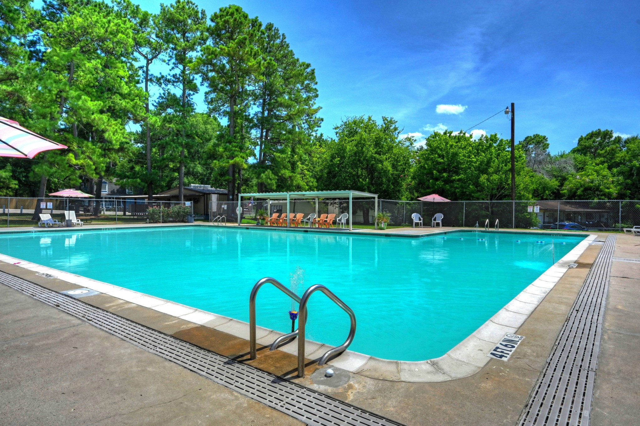 9812 Arbor Oak Willis, TX 77318 - Photo 28 of 40 a view of a swimming pool with a patio