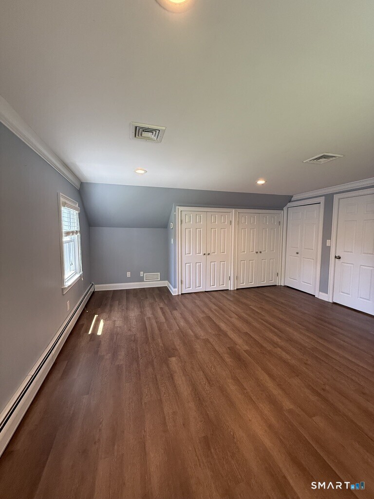 2182 North Benson Road Fairfield, CT 06824 - Photo 21 of 21 an empty room with wooden floor and windows