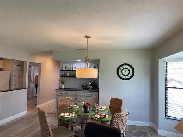 a dining room with furniture and a window