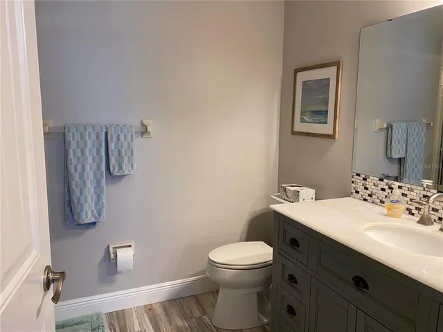 a bathroom with a sink a toilet and shower curtain
