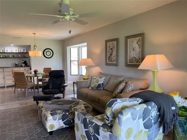 a living room with furniture a clock and a lamp