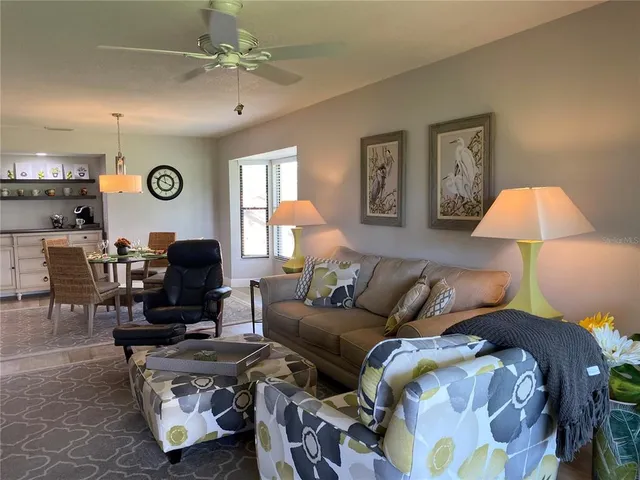 a living room with furniture a clock and a lamp