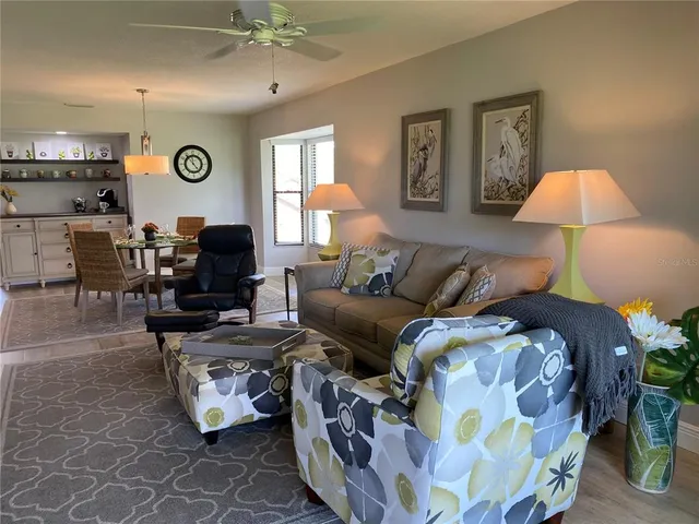 a living room with furniture and a lamp