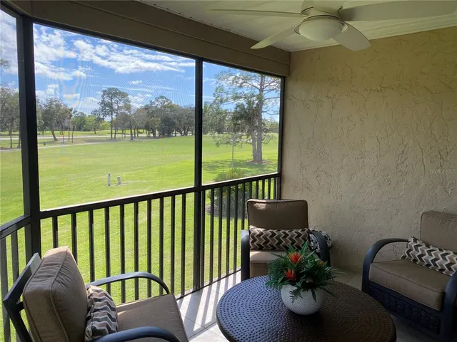 a balcony with furniture and a potted plant