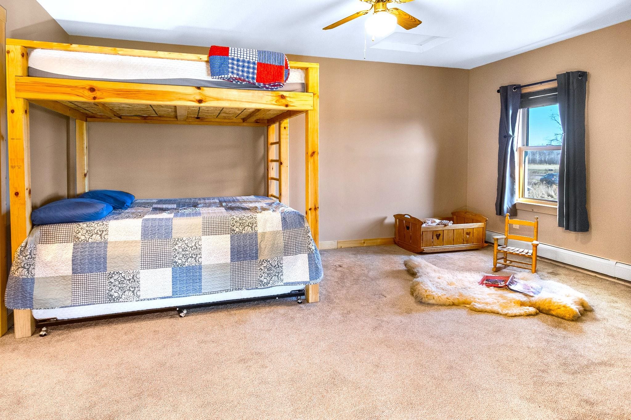 6014 Brown Road Kettle River, MN 55757 - Photo 18 of 54 Carpeted bedroom with baseboards and ceiling fan