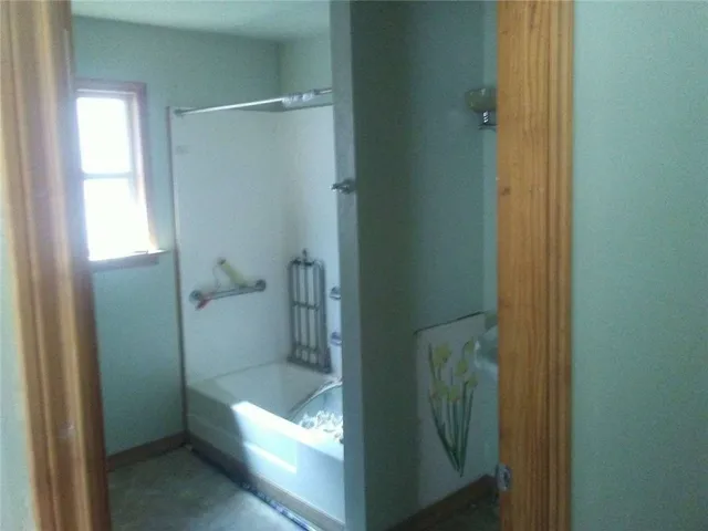 a bathroom with a glass shower door