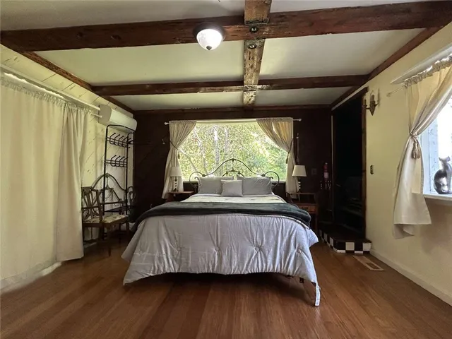 a bedroom with a bed and a large window