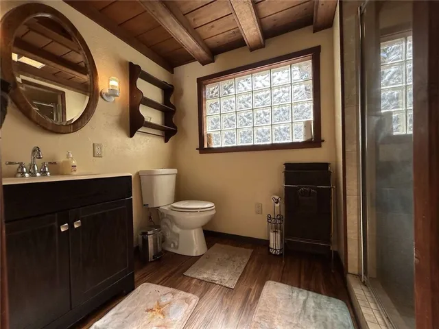 a bathroom with a toilet sink and mirror