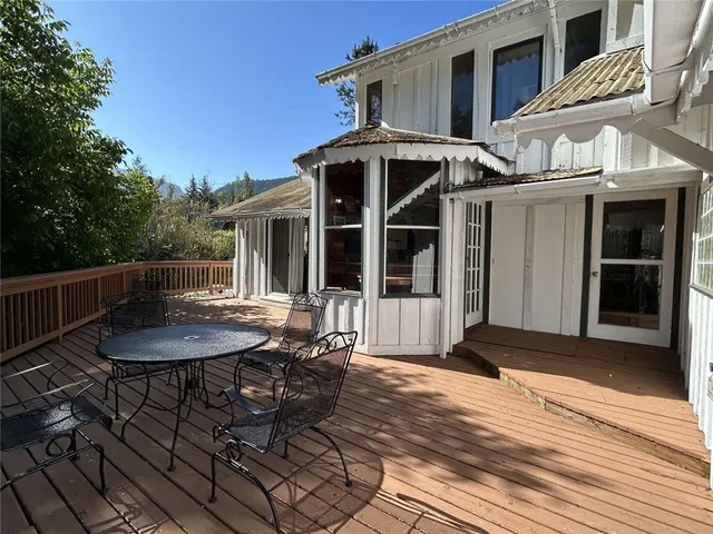 a backyard of a house with table and chairs