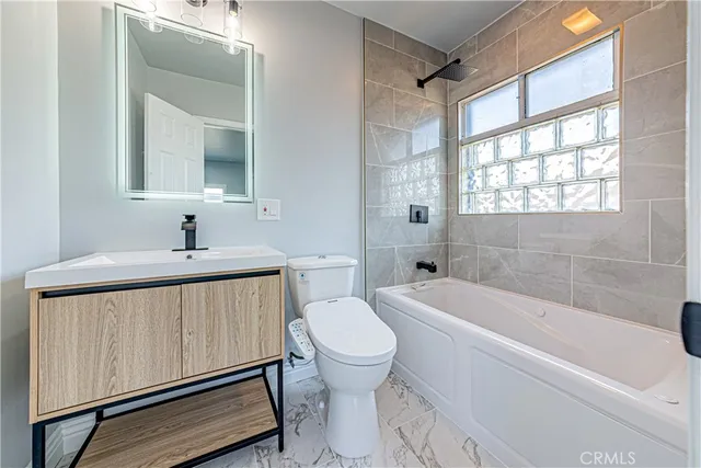 a spacious bathroom with a double vanity sink mirror and toilet