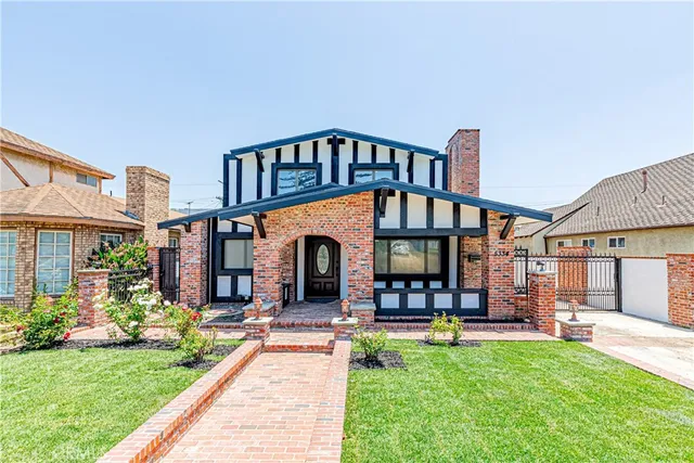 a view of a house with a yard and sitting area