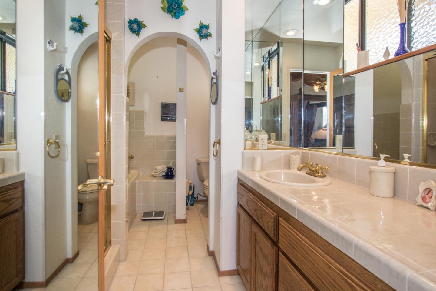 105 Mountain View Road Watsonville, CA 95076 - Photo 17 of 26 a spacious bathroom with a granite countertop sink and a mirror