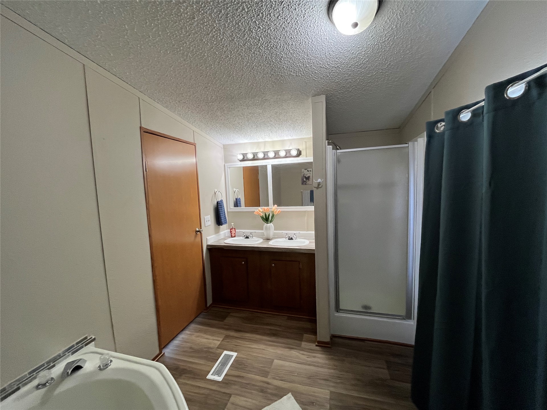 428628 East 1133 Road Porum, OK 74455 - Photo 10 of 16 Dual vanity with undermount sinks, wood-finish cabinetry, and a framed mirror