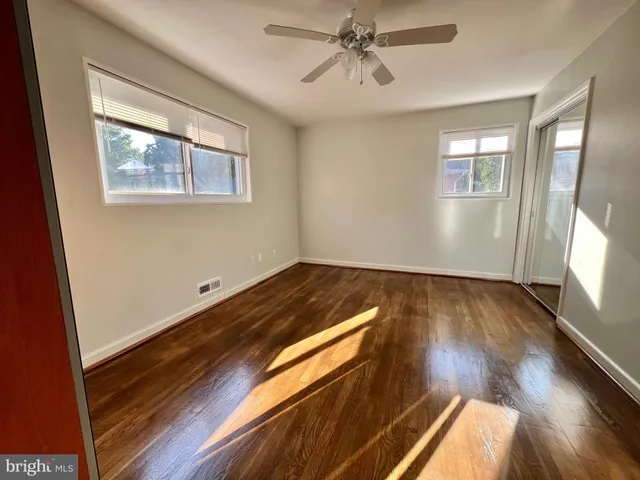 a view of room with window and wooden floor