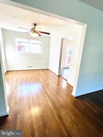 a view of a room with wooden floor and natural light