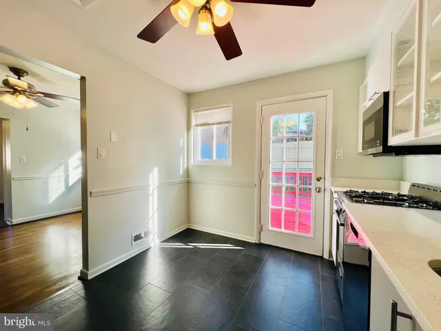 a kitchen that has a stove and a wooden floor