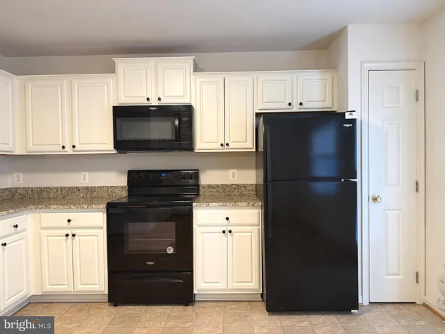 a kitchen with a refrigerator stove and microwave