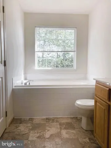 a bathroom with a toilet sink and window