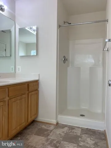 a bathroom with a shower and a sink