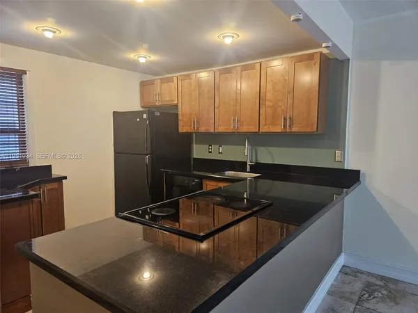 a kitchen with a sink and a refrigerator