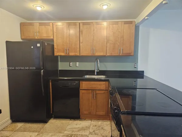 a kitchen with a refrigerator and cabinets