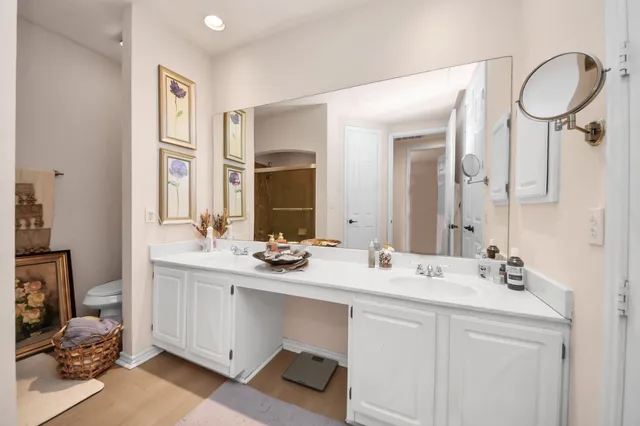 a bathroom with a double vanity sink mirror and