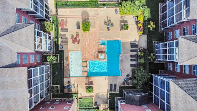 a aerial view of multi story residential apartment building with yard