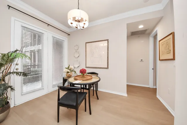 a view of a dining room with furniture wooden floor and chandelier