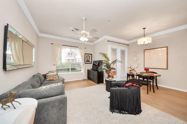 a living room with furniture and a chandelier