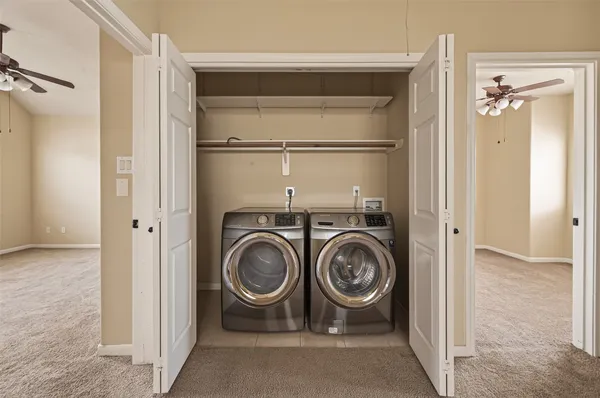 a utility room with closet dryer and washer
