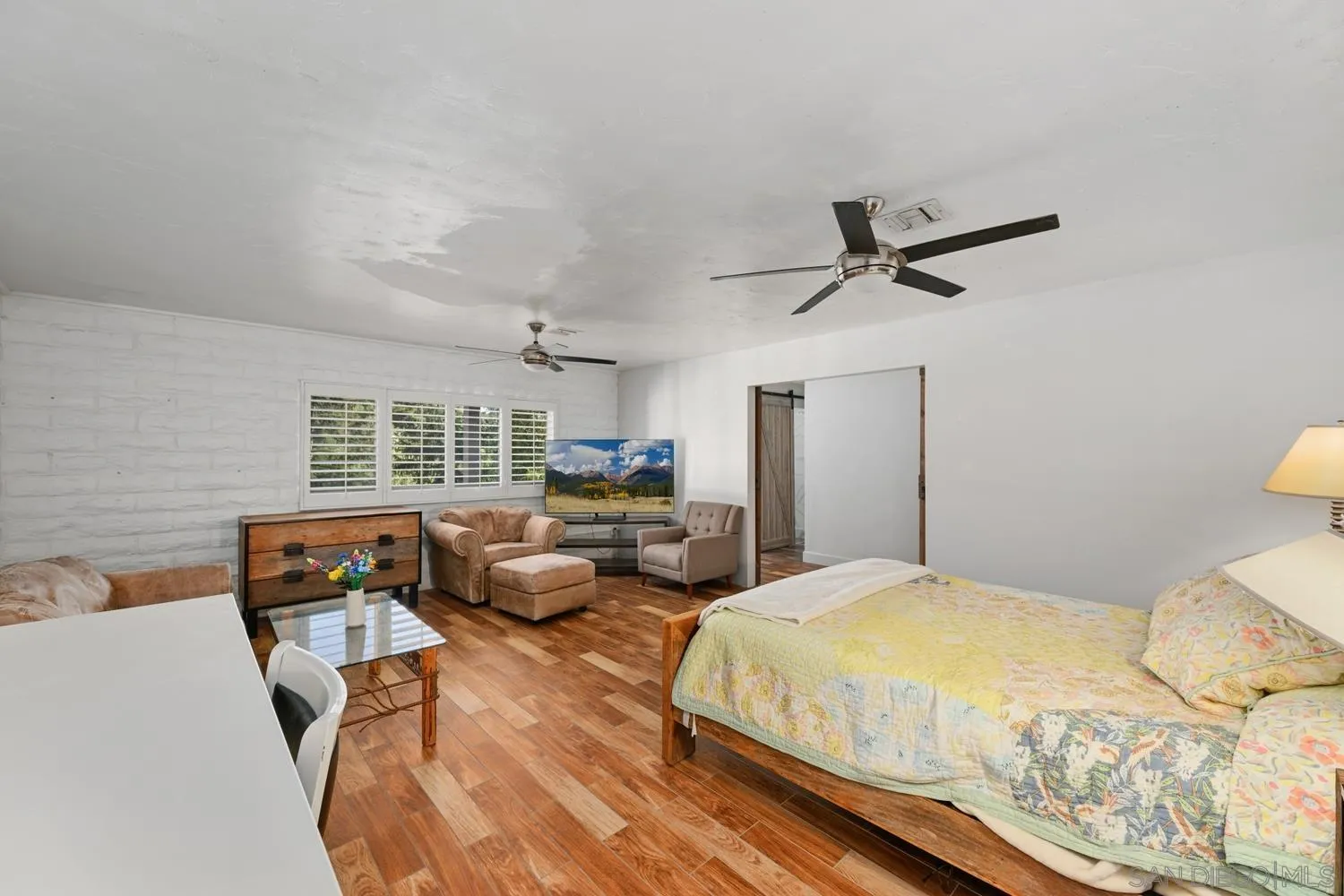 26138 Jesmond Dene Road Escondido, CA 92026 - Photo 18 of 34 a bedroom with a bed a couch and a large window