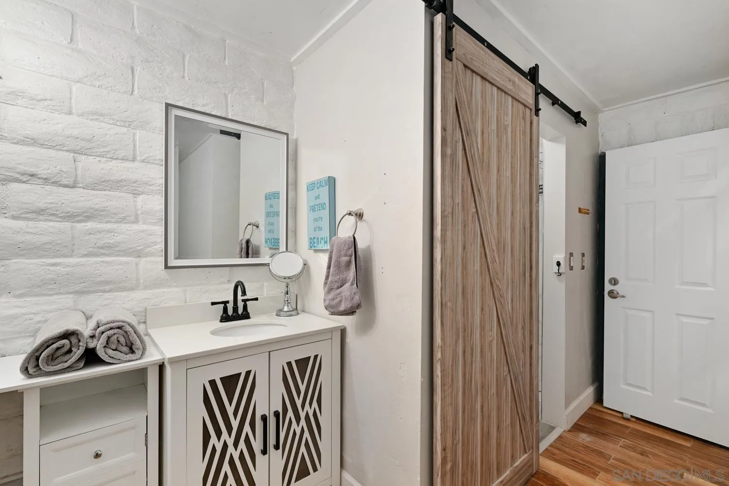 26138 Jesmond Dene Road Escondido, CA 92026 - Photo 20 of 34 a bathroom with a sink a mirror and shower
