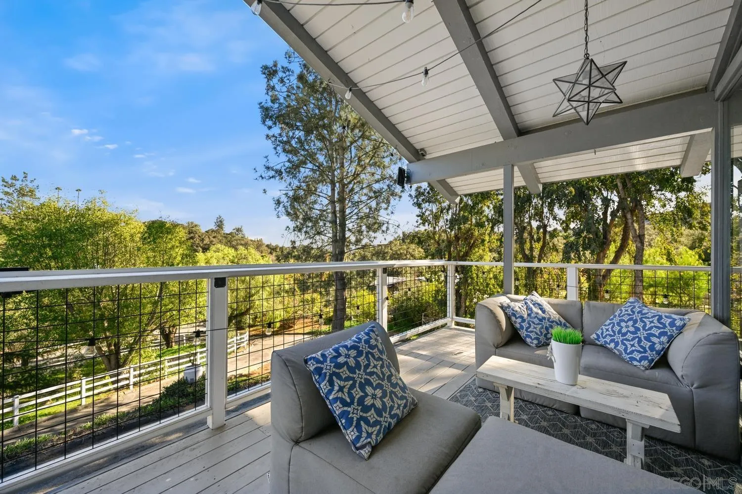 26138 Jesmond Dene Road Escondido, CA 92026 - Photo 22 of 34 a balcony with wooden floor and outdoor seating