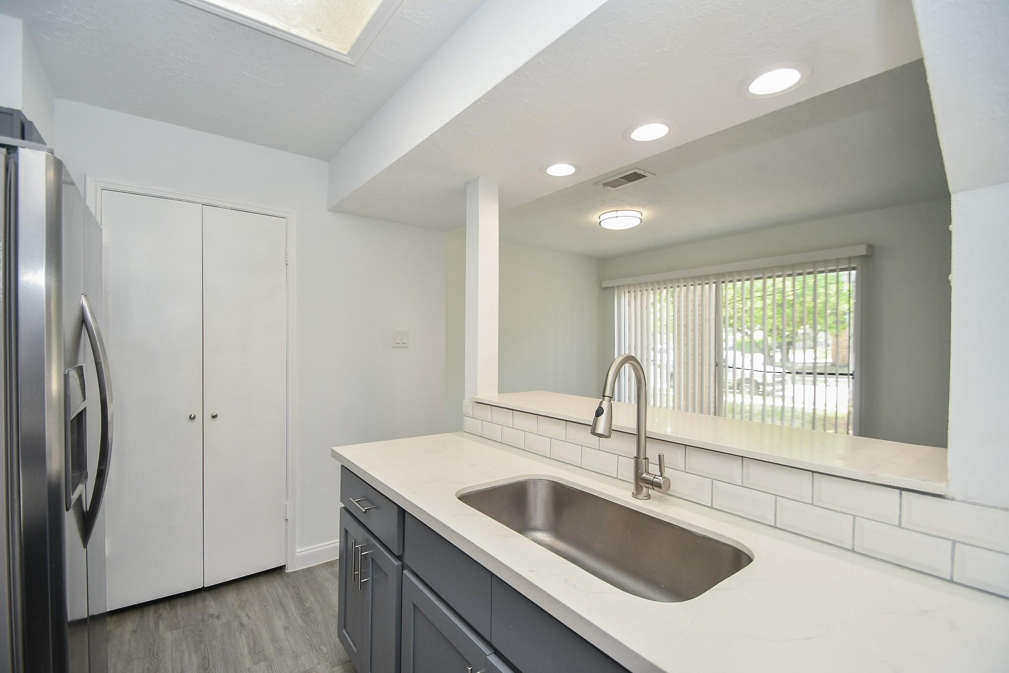 8803 Vinkins Road Houston, TX 77071 - Photo 6 of 13 a kitchen with stainless steel appliances granite countertop a sink and a refrigerator
