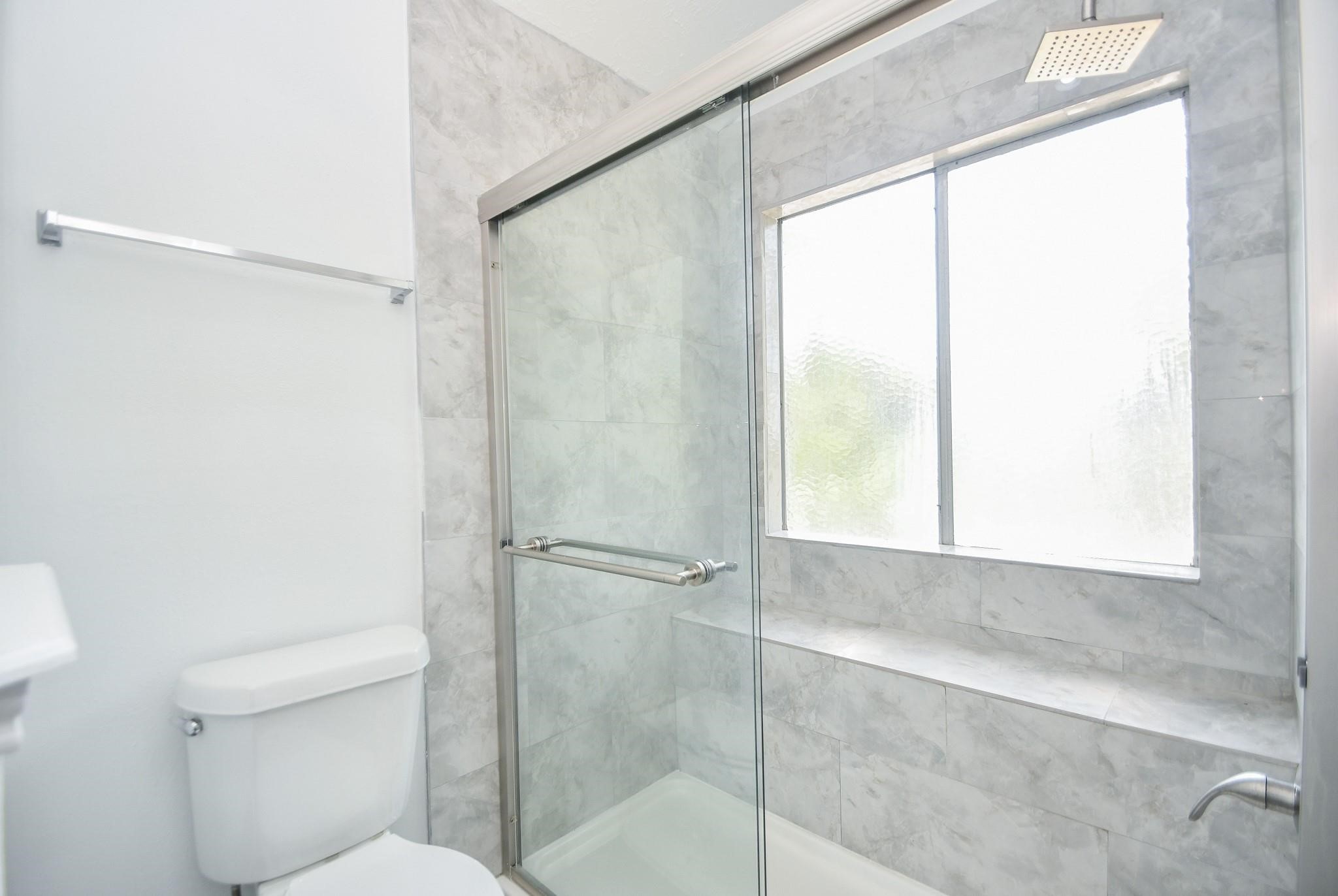 8803 Vinkins Road Houston, TX 77071 - Photo 7 of 13 a bathroom with a shower and a toilet