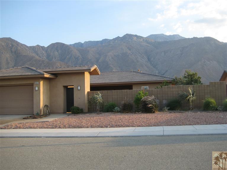 a front view of house with a garden