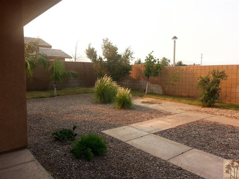 60143 Range View Drive Palm Springs, CA 92262 - Photo 2 of 11 a view of a dry yard with wooden fence