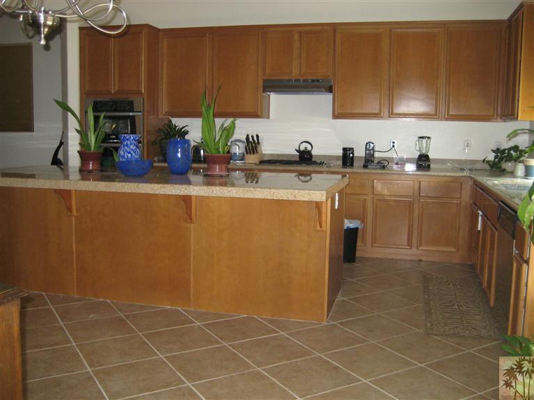 60143 Range View Drive Palm Springs, CA 92262 - Photo 3 of 11 a kitchen with stainless steel appliances a sink a stove top oven a counter space and cabinets