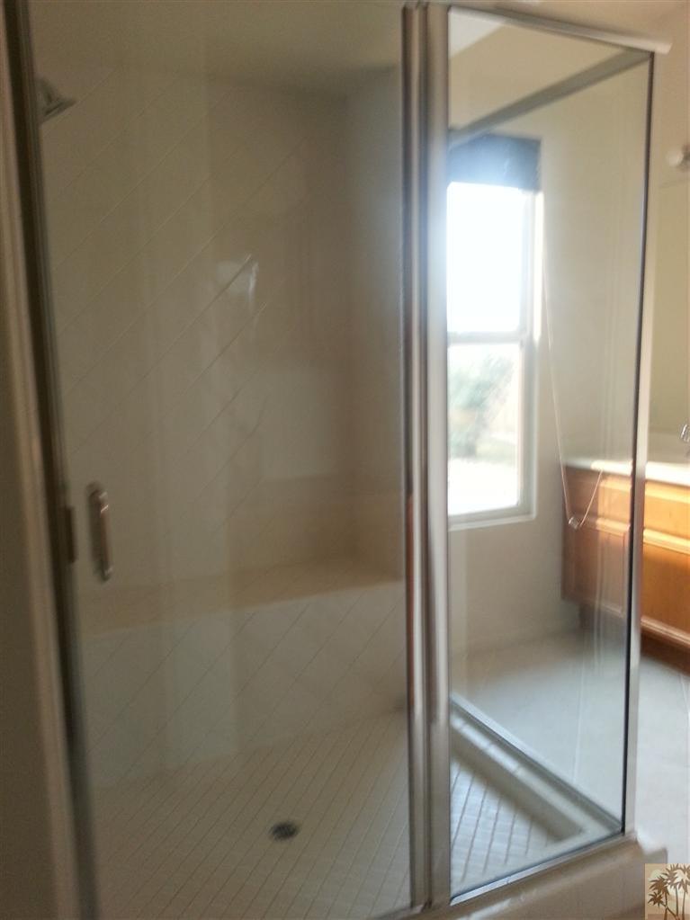 60143 Range View Drive Palm Springs, CA 92262 - Photo 5 of 11 a bathroom with a glass shower door