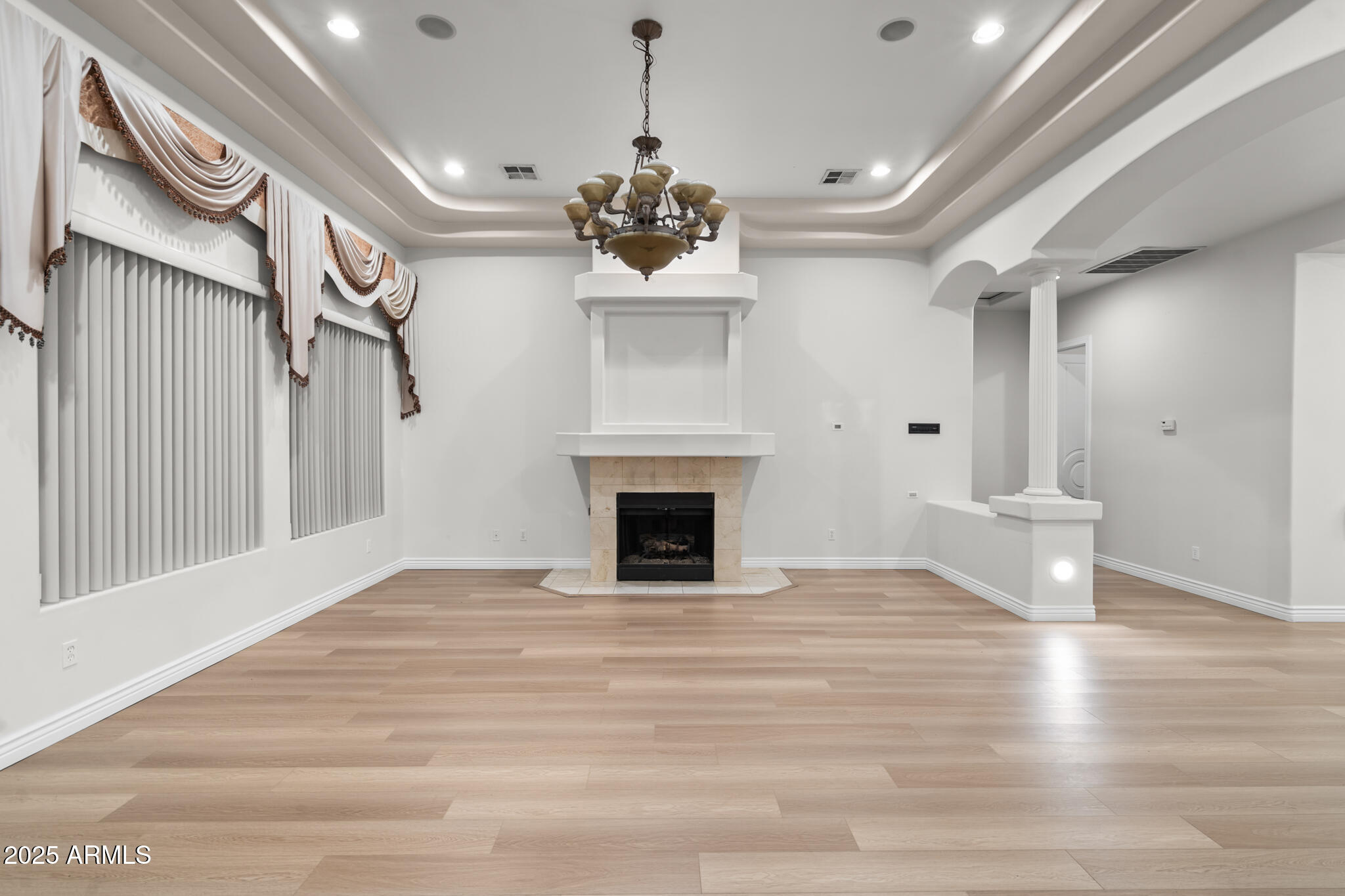 6829 North 14th Street Phoenix, AZ 85014 - Photo 16 of 53 a view of a livingroom with a fireplace wooden floor and windows