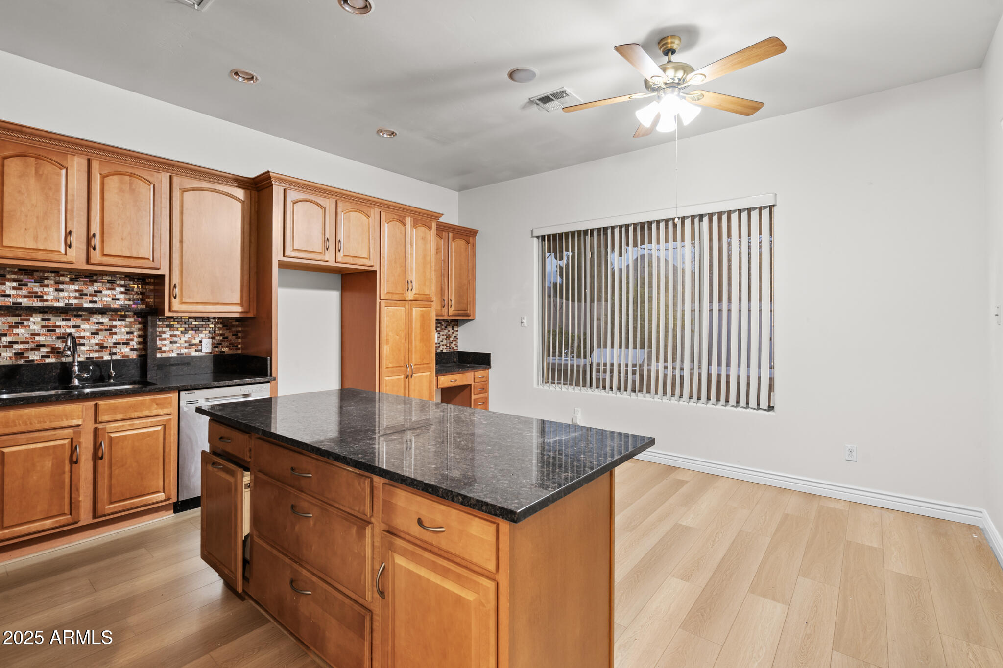 6829 North 14th Street Phoenix, AZ 85014 - Photo 17 of 53 a kitchen that has a lot of cabinets in it and wooden floors