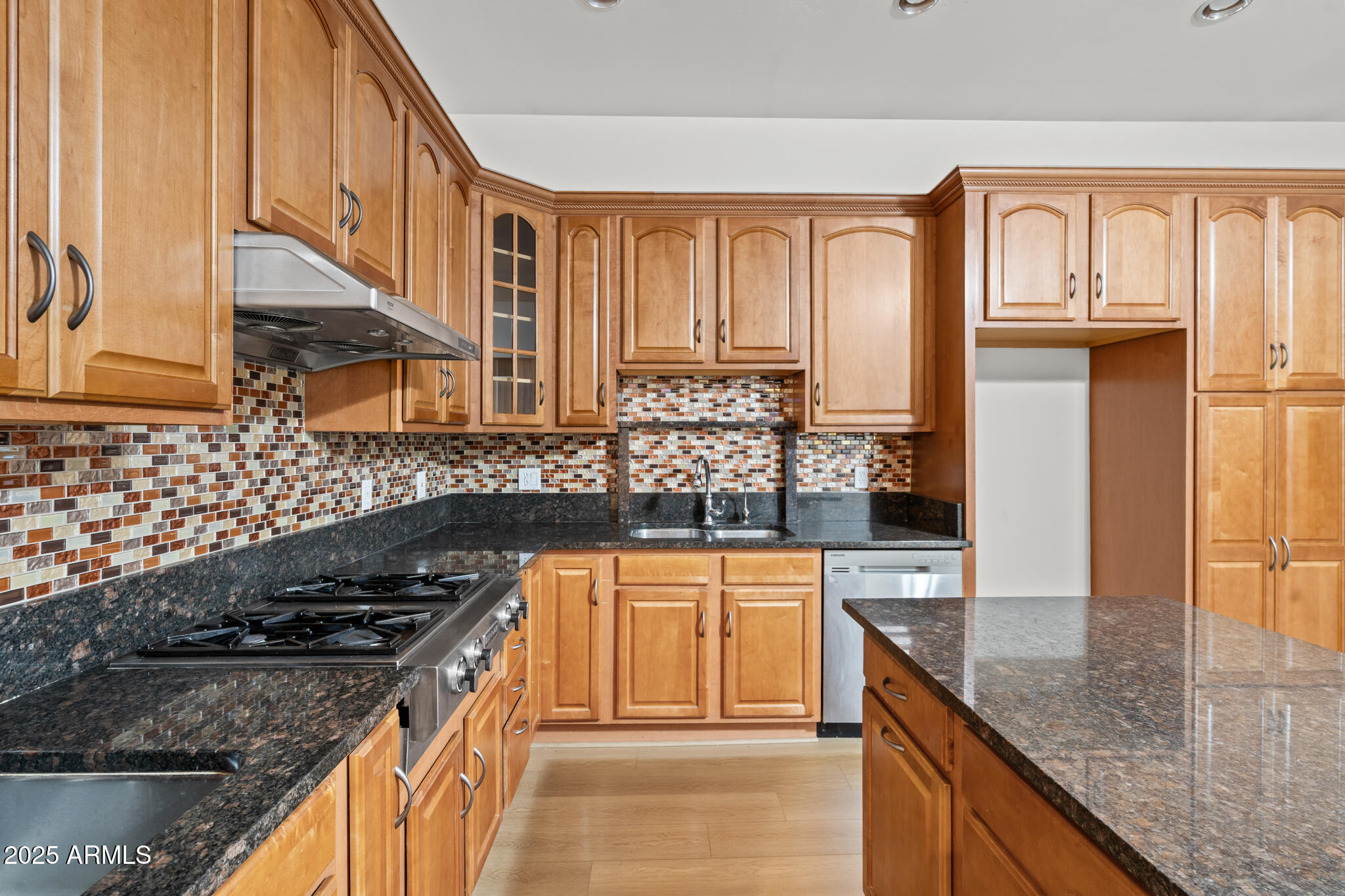 6829 North 14th Street Phoenix, AZ 85014 - Photo 18 of 53 a kitchen with stainless steel appliances granite countertop a stove a sink and a microwave