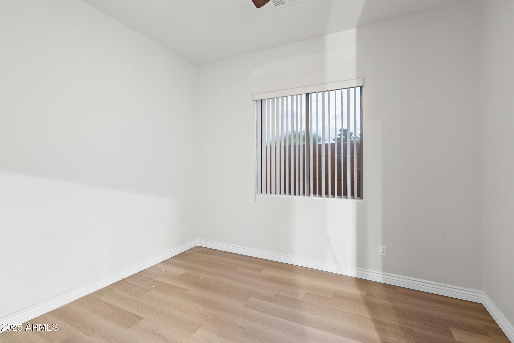 6829 North 14th Street Phoenix, AZ 85014 - Photo 23 of 53 a view of an empty room with wooden floor and a window