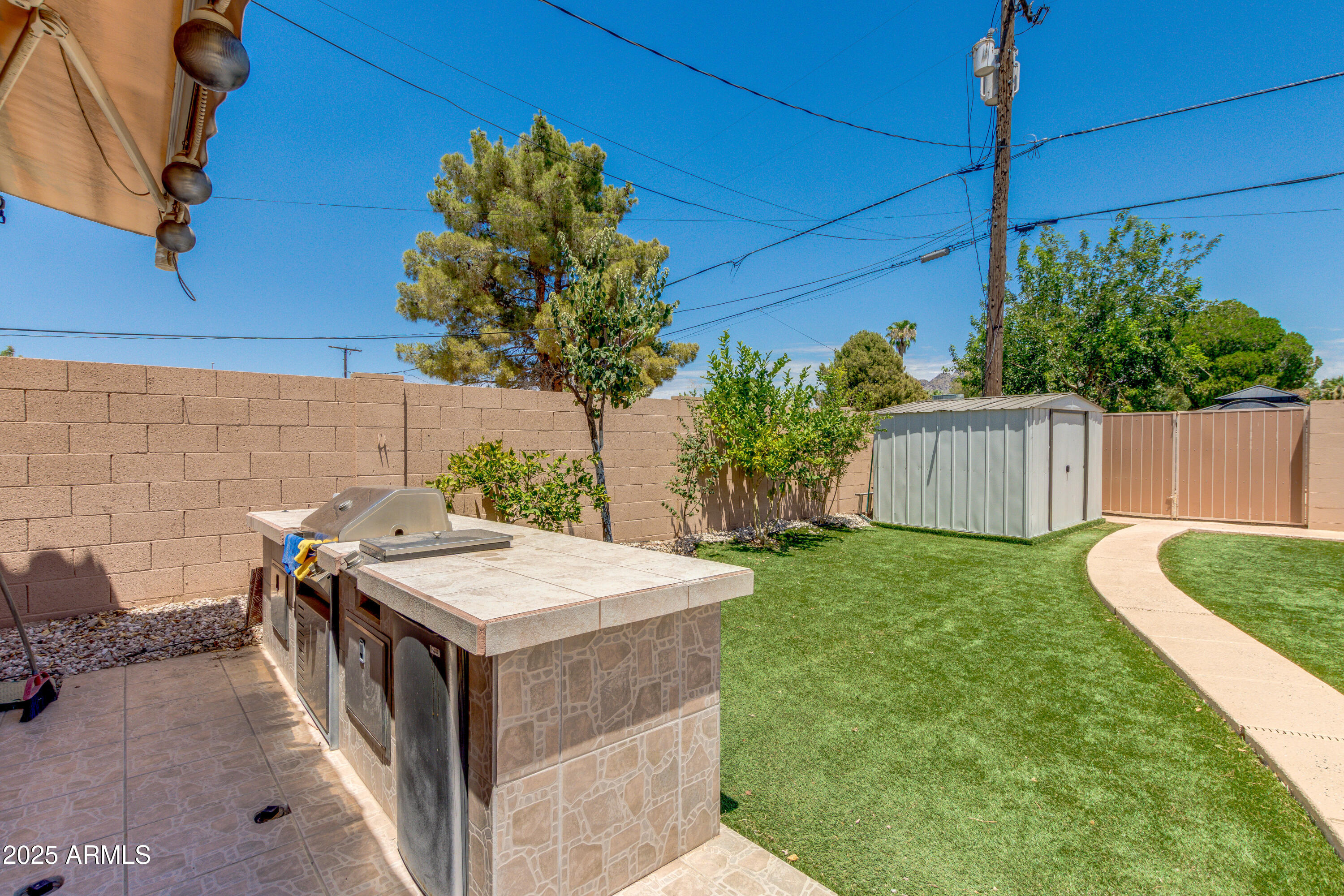 6829 North 14th Street Phoenix, AZ 85014 - Photo 39 of 53 a view of a backyard with plants and a patio
