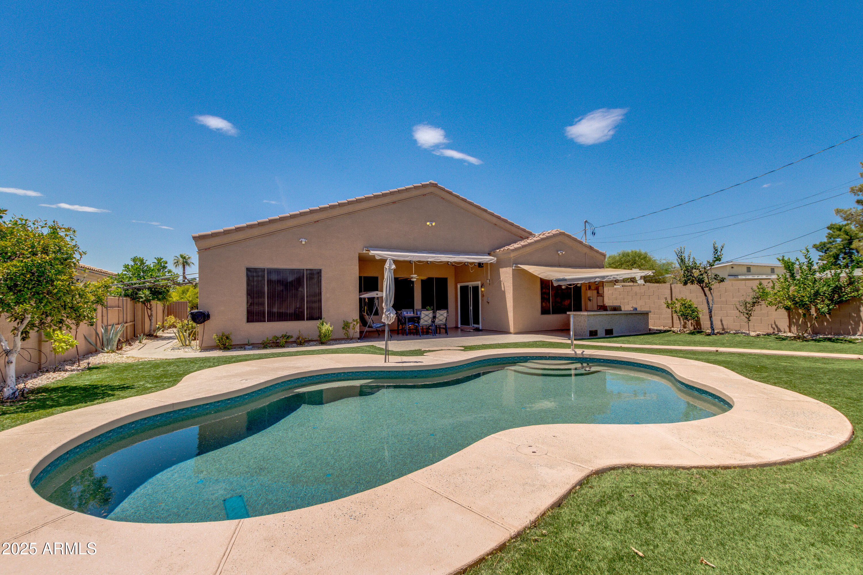 6829 North 14th Street Phoenix, AZ 85014 - Photo 43 of 53 a view of a house with swimming pool and yard