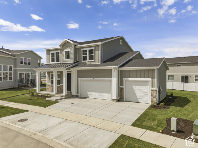 79 South Crimson Way West, Unit 307 Mapleton, UT 84664 - Photo 2 of 42 Two-story exterior with a covered porch, stone accents, and a dual garage