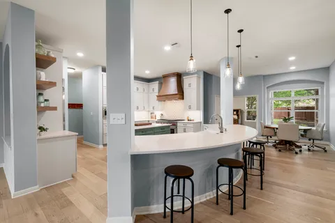 a large kitchen with a table and chairs