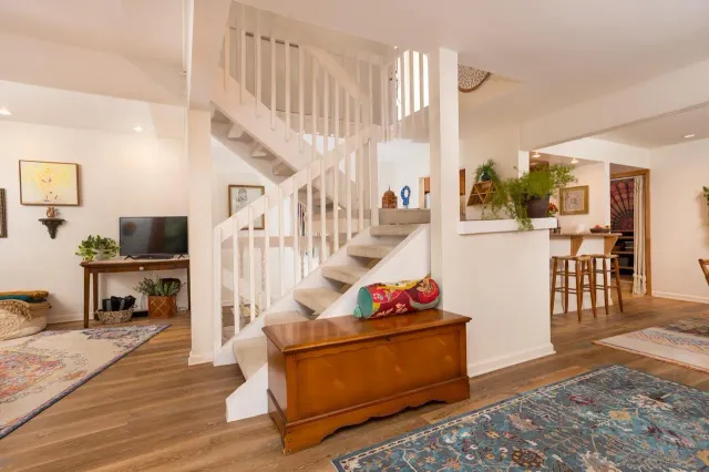a dining room with furniture and wooden floor